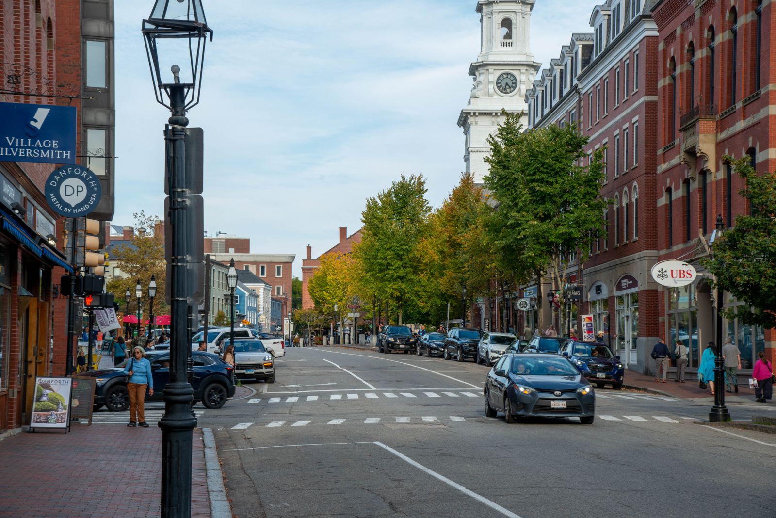 Historic New England town street with church steeple in autumn