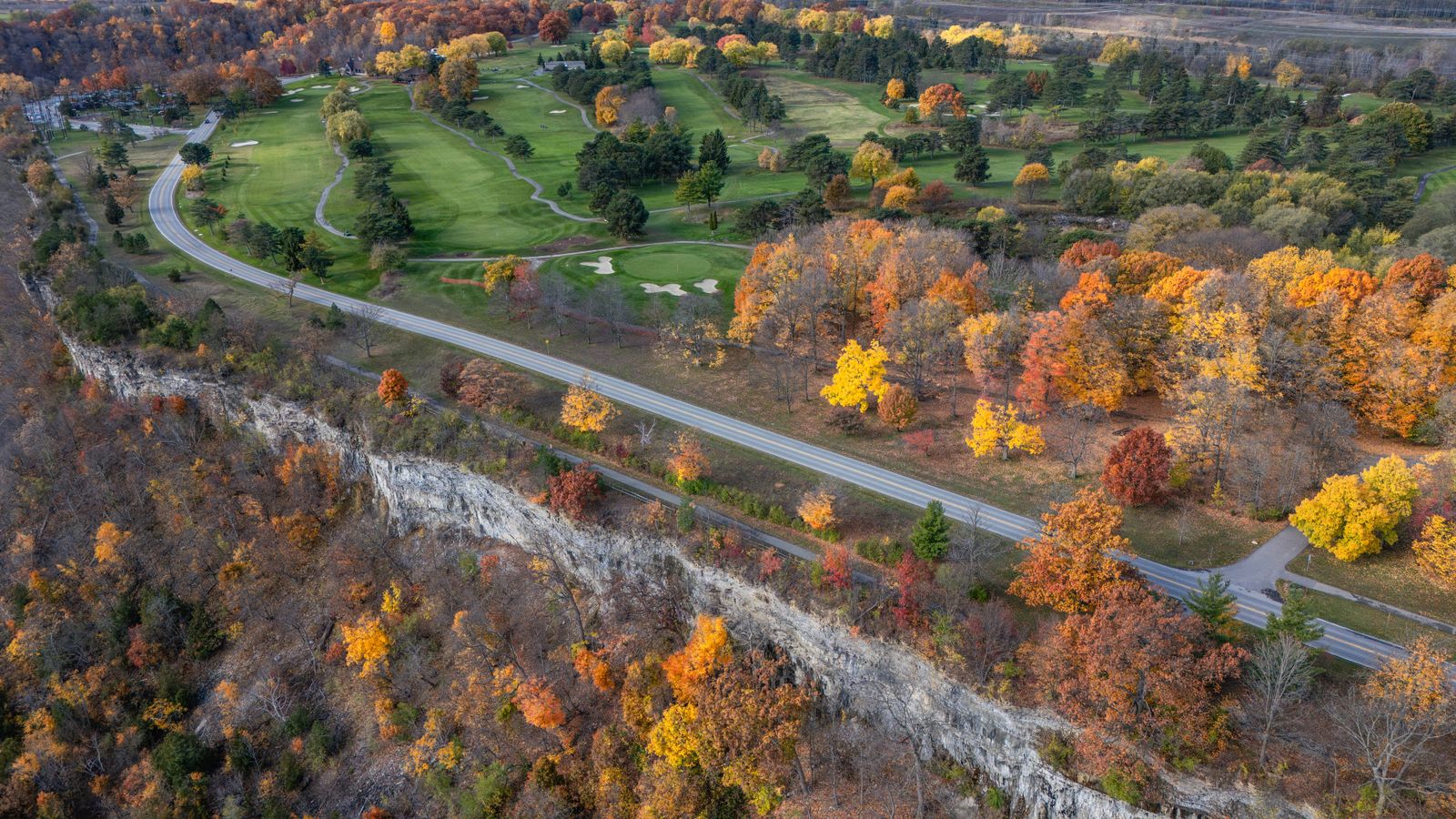 Golf course winding through brilliant autumn foliage